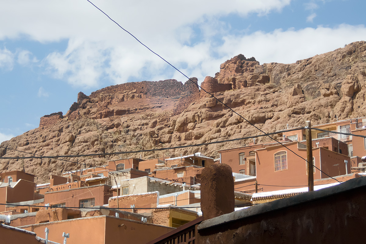 A part od Abyaneh village with ruins of the fortress on top of the overlooking hill. Exquisite planning of  electric cable lines adorns the village an uniquely charming way... same as many other villages from Kandovan on...