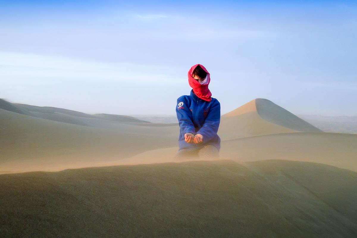Izabel fighting the desert wind. Photo Mitja Roner